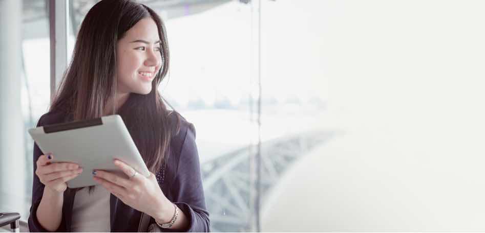 woman with ipad looking out the window